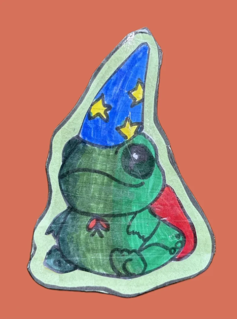 A colourful drawing of a sitting frog wearing a pointed wizard hat and cape.