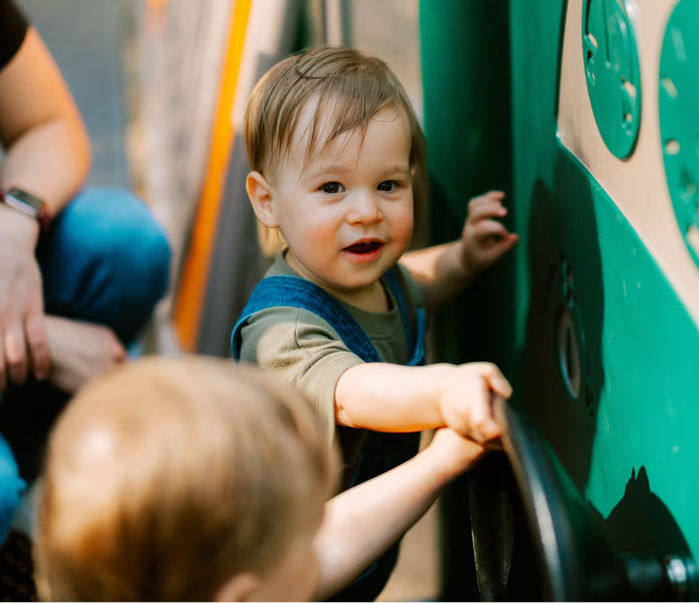 Child playing on a colourful playground slide